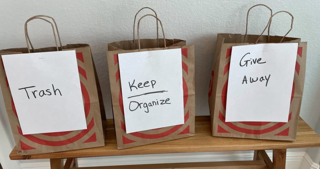 3 bags labeled trash, keep/organize, and give away