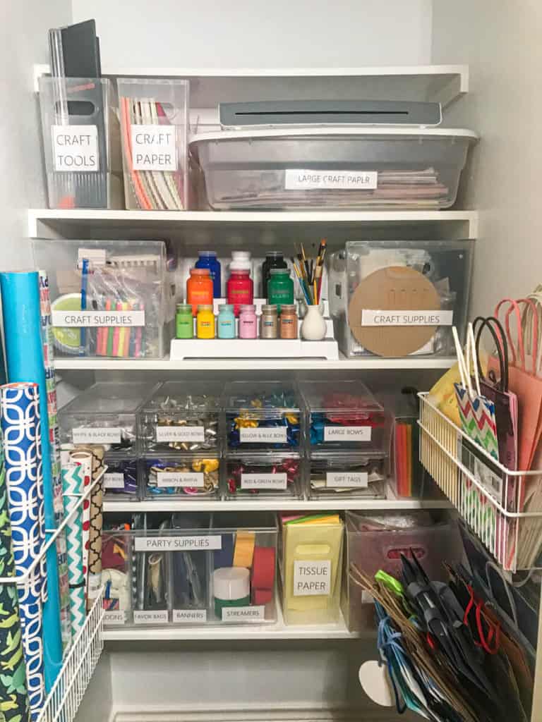 A closet used for organizing craft supplies gift wrap.