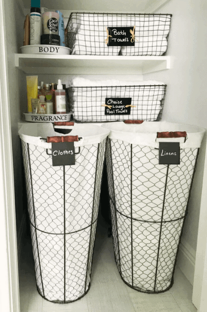 Wire and fabric lined hampers in a neatly organized linen closet