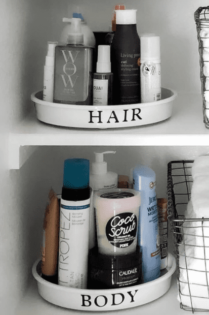 Turntables holding hair and beauty products in an organized linen closet