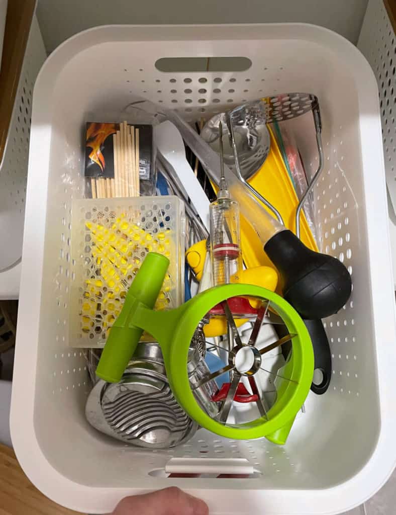 A bin filled with kitchen utensils and gadgets