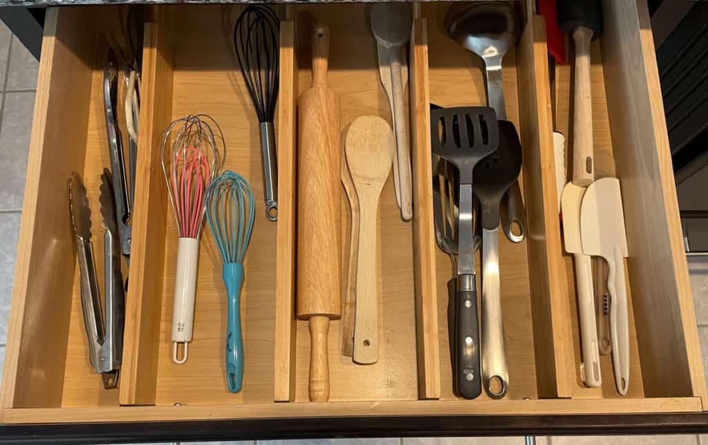 A neatly organized kitchen utensil drawer using bamboo drawer dividers