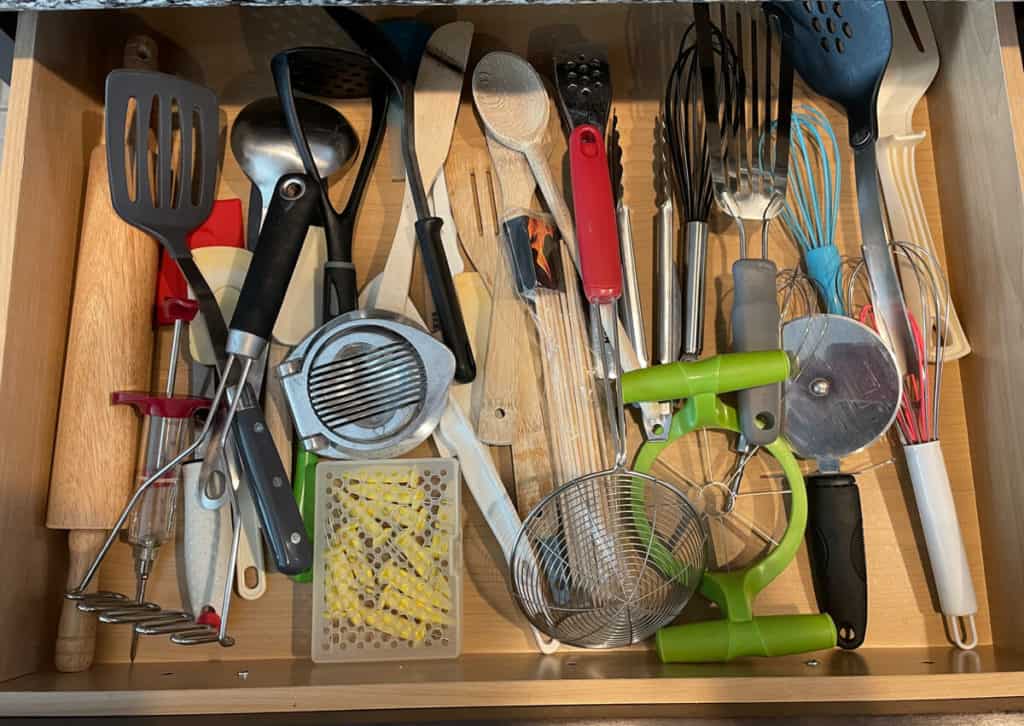 A very disorganized and messy kitchen drawer