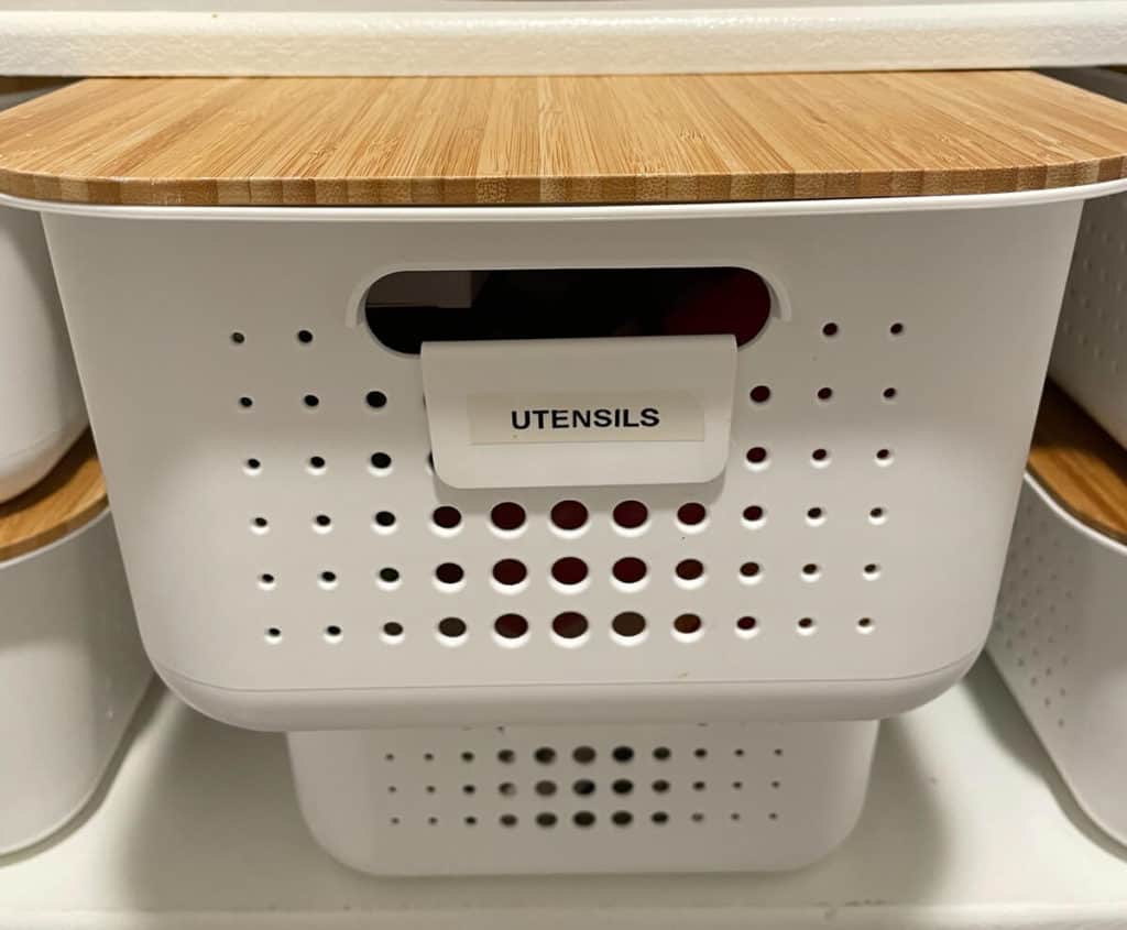 A pantry bin labeled utensils