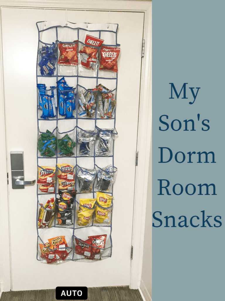 An over-the-door shoe organizer in a dorm room with each pocket filled with snacks