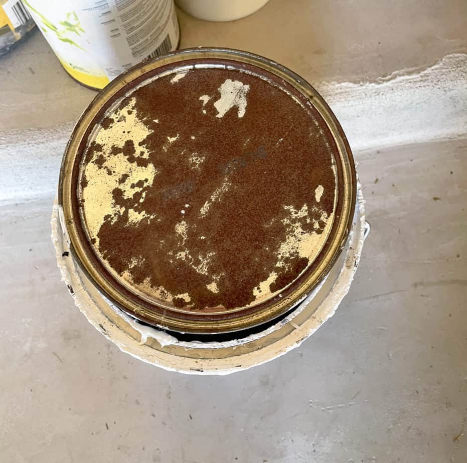 A very rusty paint can lid
