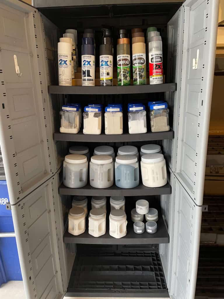 A garage storage cabinet filled with paint
