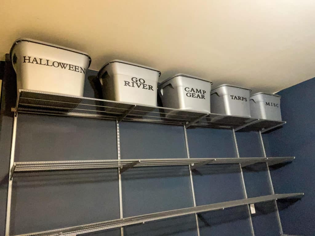 Garage shelving with storage bins on one of the shelves