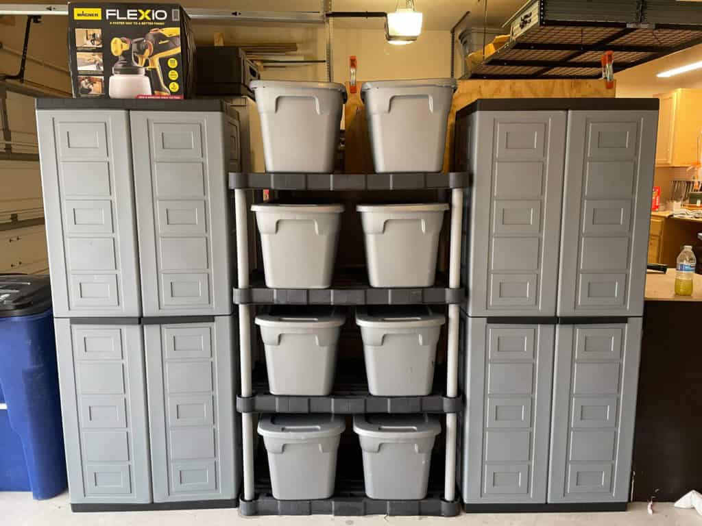A garage divided in half using extra garage storage and trash cans as the dividing line